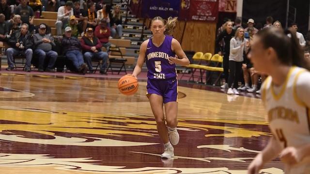 Natalie Bremer drives to the basket in DII women's basketball.