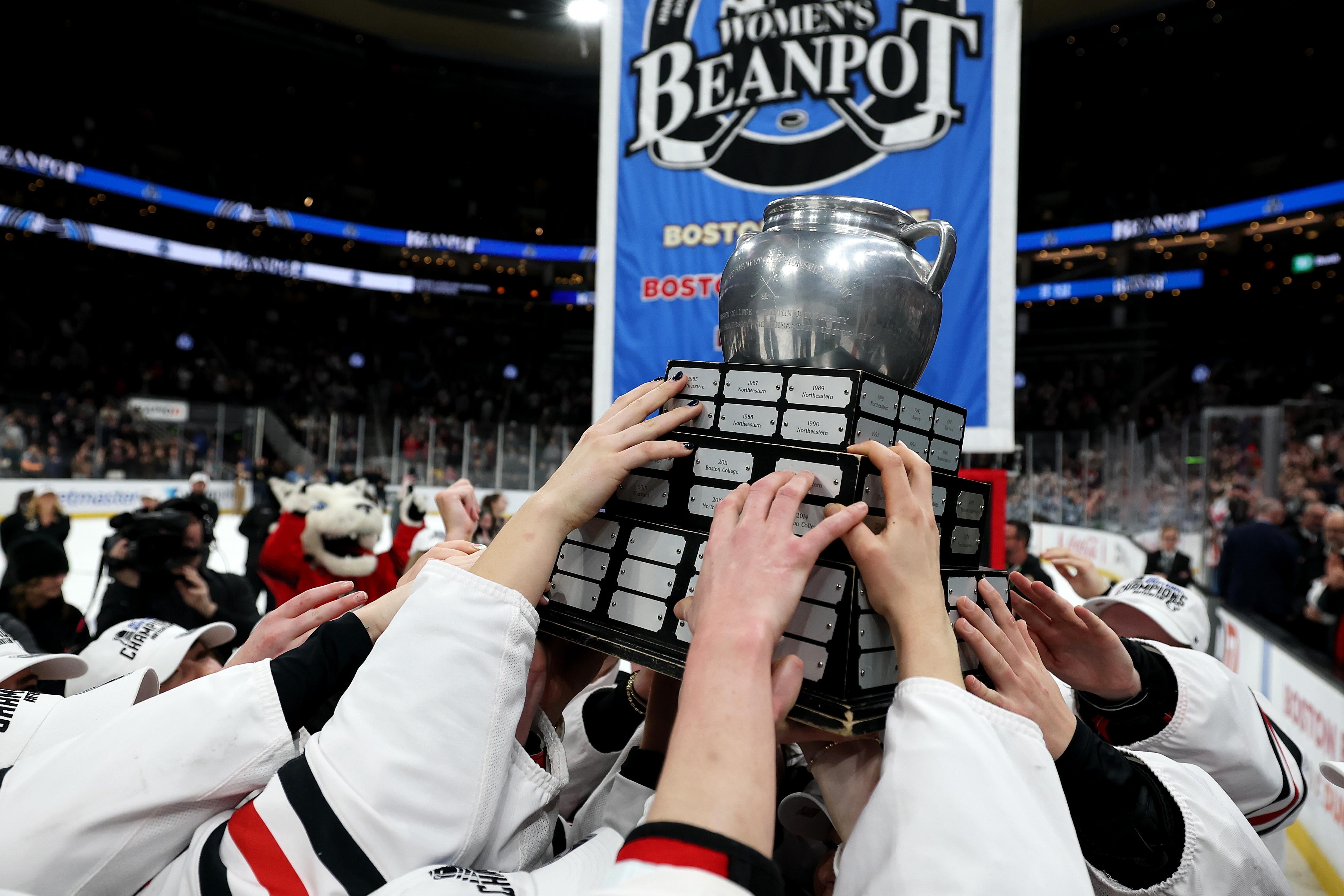 The Northeastern Huskies hoist the Beanpot trophy as winners of the 2025 Women's Beanpot tournament